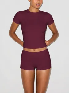 Women casual slim fit short sleeve crop top and matching tight athletic shorts set.