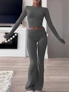 Casual women's two piece workout set long sleeve crop top and flare pants for daily gym wear.