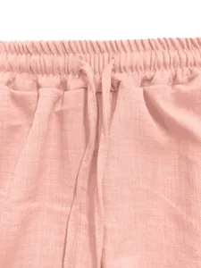 Close-up detail of women's casual pink elastic waist shorts with adjustable drawstrings.