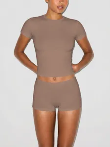 Close-up detail of women short sleeve crop top and boxer shorts set in taupe, slim fit.