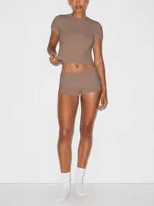 Detailed view of the fitted brown short-sleeve crop top and matching shorts set, soft fabric.