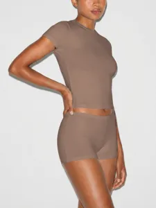 Close-up detail of the slim brown short-sleeve top and matching shorts loungewear set.
