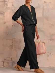 Detailed view of the black casual two-piece set, featuring a stylish zip top and wide-leg trousers.