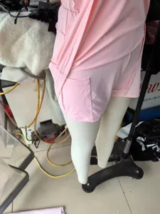 Pink athletic tennis romper detail showing built-in shorts and convenient side pocket design.