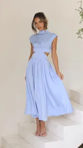 Detail shot of a light blue waist cutout midi dress worn by a model on white steps scene.