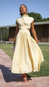 Outdoor lifestyle detail shot showcasing the stylish cut-out waist and elegant pleated skirt.
