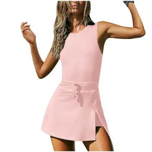 Pink fitness tennis dress for women, sleeveless athletic romper with built-in shorts and drawstring.