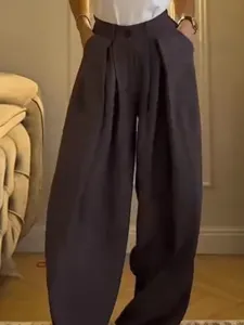 Detailed shot of women high waist pleated wide leg trousers, casual loose fit apparel.