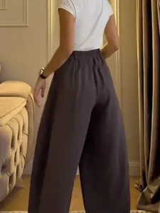 Detail view of casual loose wide-leg pants in dark grey, featuring a comfortable drawstring waist.