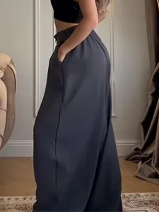 Detail view of comfortable loose wide leg trousers showing side pocket and relaxed drape.