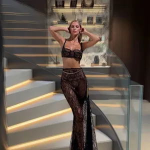 Detailed view of sexy black lace two-piece camisole and sheer fishtail pants set.