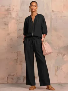 Detailed full view showcasing the black casual zip top and wide-leg trousers set.