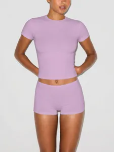 Detailed view of the light purple slim crop top and tight shorts activewear set, soft fabric.