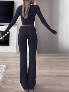 Detailed view of the casual women's two-piece crop top and flare pants set in deep blue.