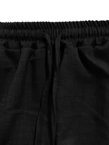 Close-up of black casual pants waistband, featuring elastic gathered design and drawstring.