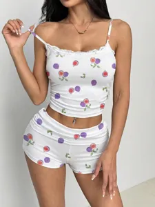 Close-up detail of the white camisole and shorts set featuring cute purple fig fruit print.