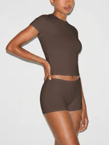 Close-up detail of the brown activewear crop top and tight shorts set, stretch fit design.