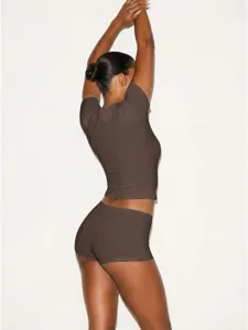 Detailed view of the brown stretch slim-fit short sleeve top and tight shorts set.
