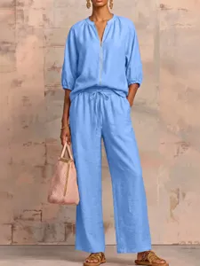 Detailed view of the stylish light blue casual zip-up top and wide-leg trouser set.