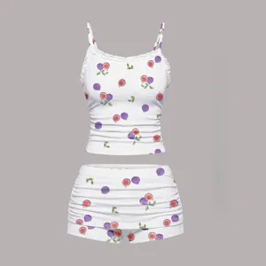 White camisole and shorts set featuring fig print, lace trim, and stylish ruching details.