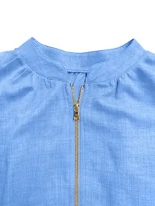Close-up detail of women's casual solid color zipper round neck top in light blue fabric.