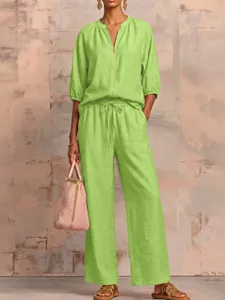Details of lime green casual two-piece set, zipper top and wide leg pants, summer fashion.