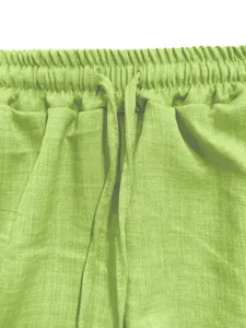 Green casual pants elastic waistband detail closeup, breathable cotton blend fabric.