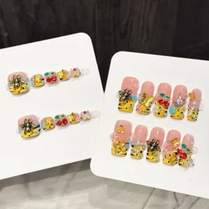 Handmade press-on toe nails with 3d bee cherry and cross charms for stylish summer pedicures