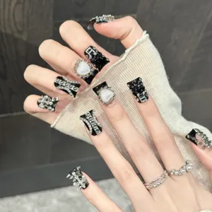 Black and silver handcrafted press-on nails with rivet star and rhinestone designs for rock style.