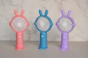 Mini ventilateur à main portable USB avec design d'oreilles de lapin mignon, rechargeable avec base.