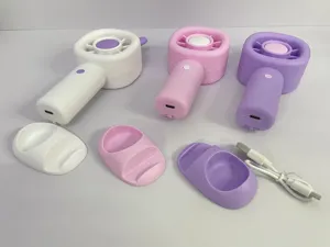 Portable handheld mini fan with base stand, USB rechargeable battery-operated desk fan for student dorm.