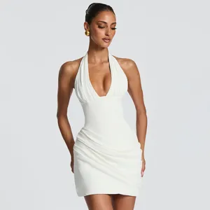 White halter pleated backless dress detail view, showing the sleeveless cut and elegant draping.
