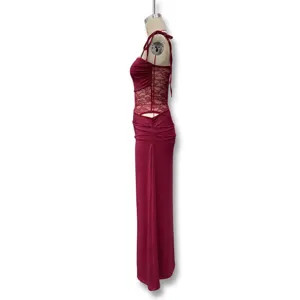 Detailed side view of the dark red lace patchwork sling dress showing side cutout and length.