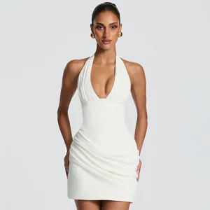 Stunning white halter neck ruched mini dress detail, sleeveless design for summer style.