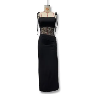Detail view of the sexy black slip maxi dress featuring lace patchwork and chic cutout waist design.