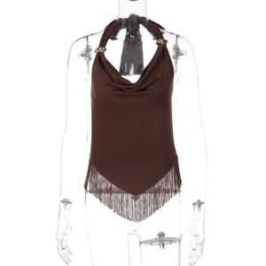 Close-up details of brown halter neck cowl top featuring fringe hem and metal rings.