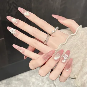 Rosa Katzenauge Kunstnägel mit 3D weißen Blumen und funkelndem Glitzer für elegante Optik.