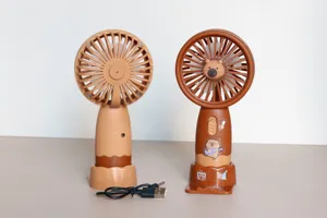 Vista dettagliata di mini ventilatori portatili con base di ricarica USB e design a orsetto.
