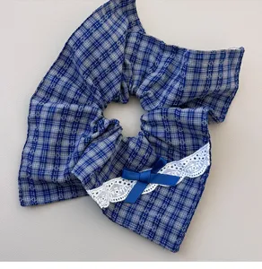 Blue plaid hair scrunchie with white lace trim and bow detail for women ponytail hair tie detail