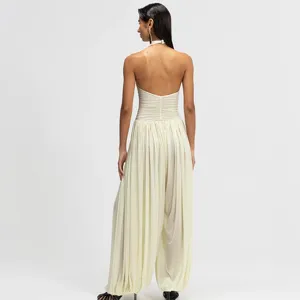 Elegant backless halter jumpsuit for women, featuring chic ruched bodice and wide leg.