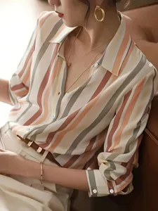 Detail shot of the stylish color-block striped women's shirt featuring elegant lapel and buttons.