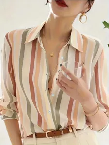 Close-up detail of women's color-contrast striped shirt featuring lapel collar and chic style.