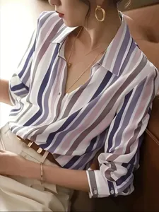 Close-up detail of women's long-sleeve color-block striped shirt, featuring classic lapel design.