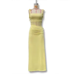 Yellow slip dress detail showing lace patchwork and hollow out transparent design style.