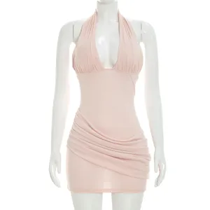 Close-up detail of the pink sleeveless halter ruched mini dress showing chic side draping.