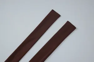 Brown fabric straps detail shot for women fashion halter top, clean studio style.