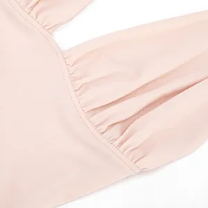 Close-up detail of women pink halter dress showing fine gathered pleats and delicate seams.