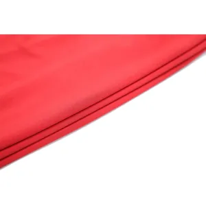 Immagine di dettaglio del materiale in tessuto rosso di alta qualità, texture morbida per abito.