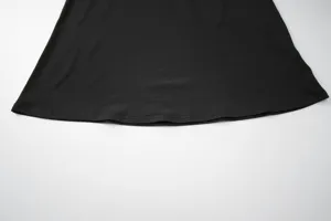 Black dress hem detail view, smooth fabric and neat stitching, elegant and simple summer style.