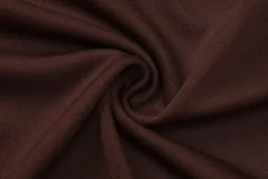 Detailed view of the soft brown textile fabric showcasing fine woven texture and natural swirls.